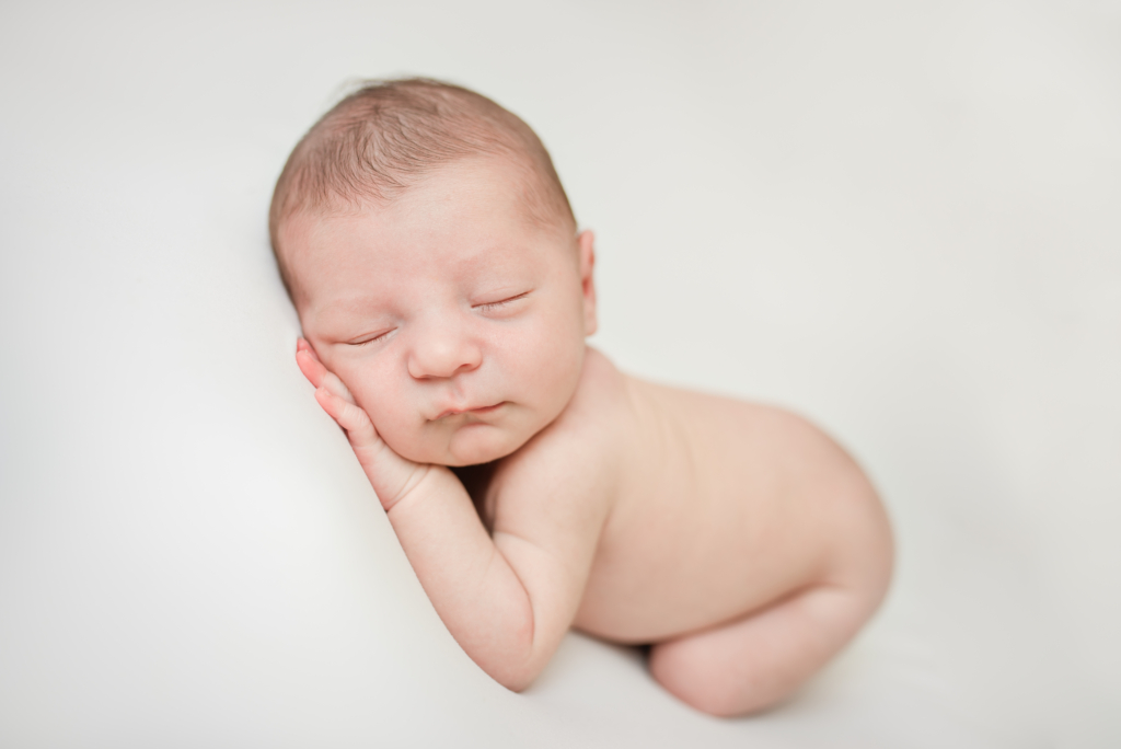 Newborn baby on white backdrop